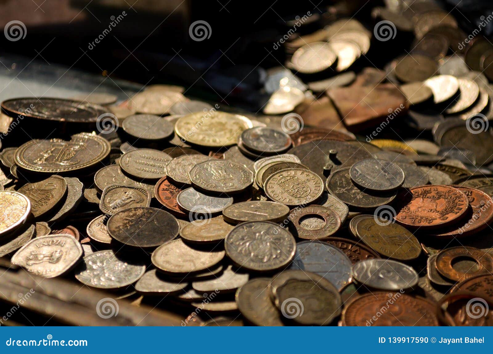 a collection of old coins kept at a roadside vendor`s shop in old delhi