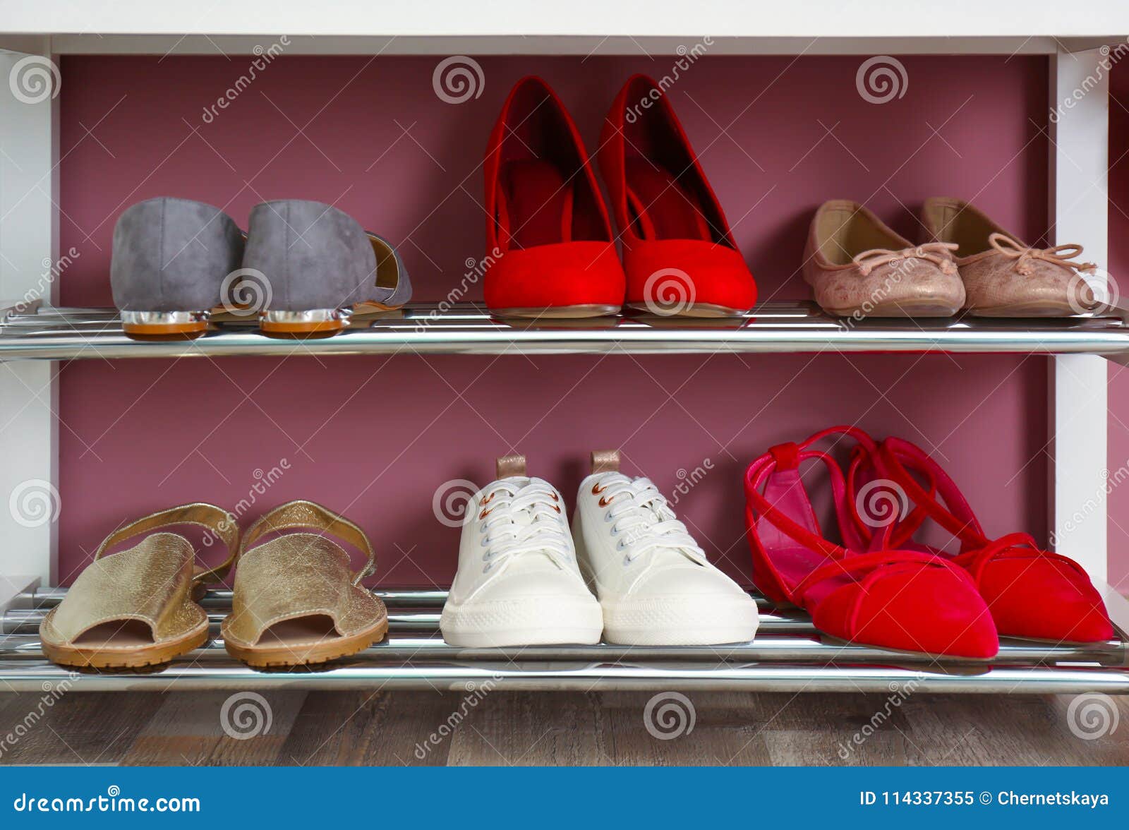 Collection of Stylish Shoes on Rack Storage Near Wall Stock Image ...
