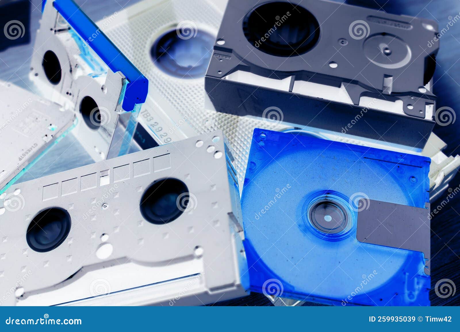 collection of vintage tape-based media cartridges, including 8mm data cartridge, vhs-c, minidisc, minidv