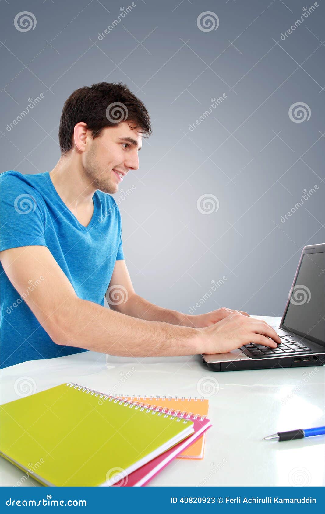 College Student Using His Laptop Computer Stock Image - Image of room ...