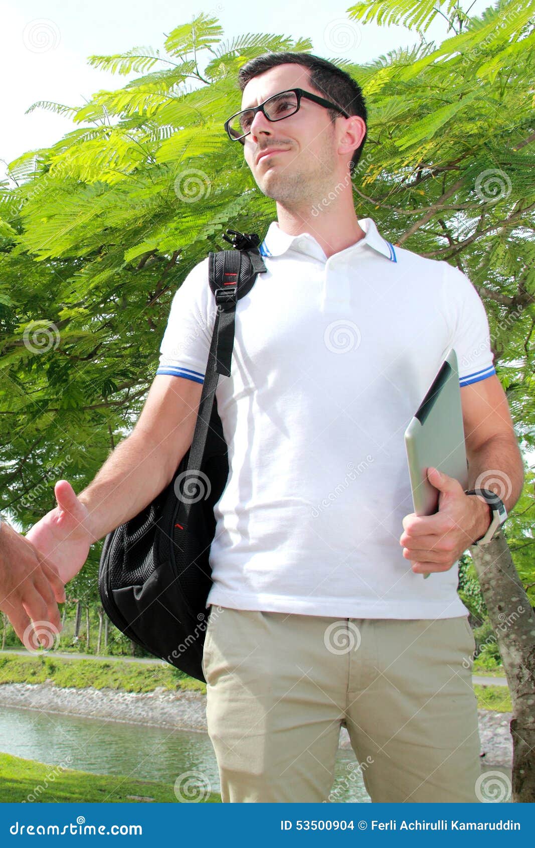 College Student Wearing Backpack and Bringing a Laptop Stock Photo