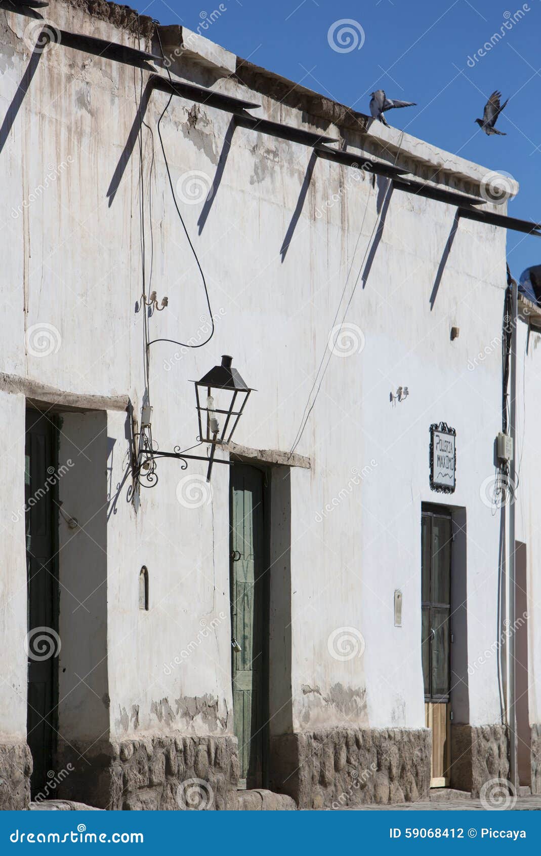 colonial architecture in cachi, blue sky and birds. argentina