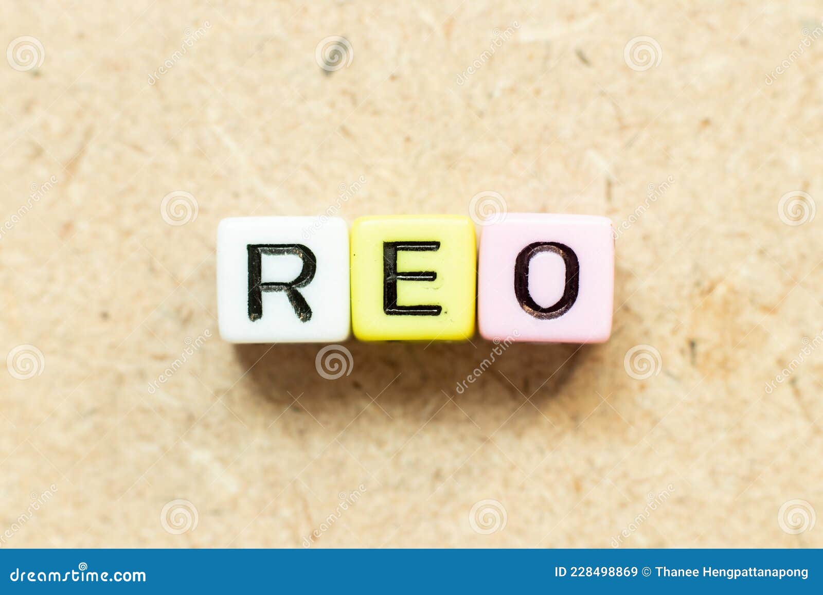 color letter block in word reo abbreviation of real estate owned on wood background