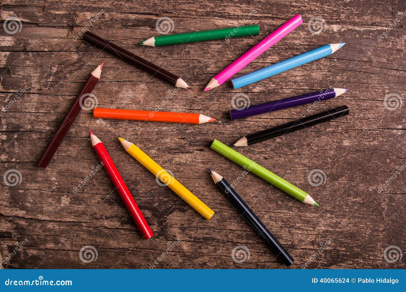 color pencils scattered on wood background