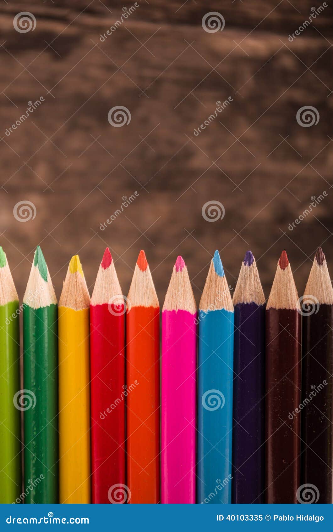 color pencils scattered on wood background