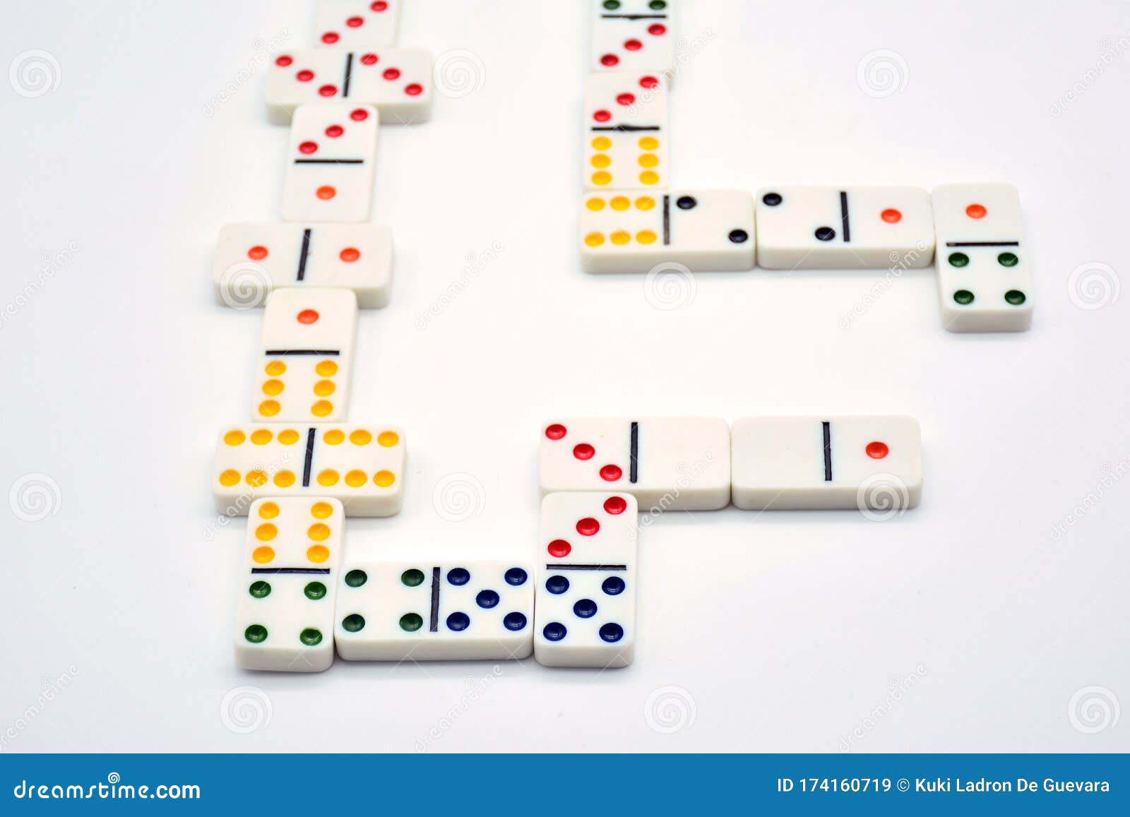 colored dominoes lined up, domino effect