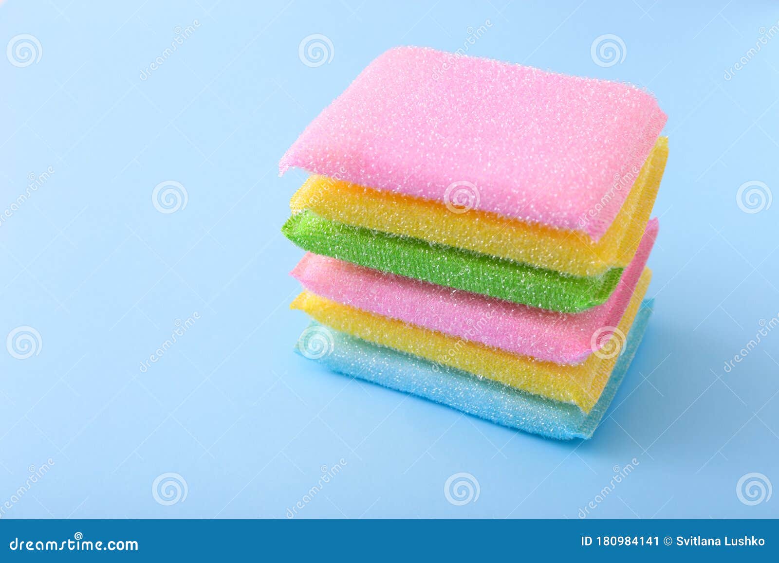 Colored Kitchen Sponges on Blue Background. Kitchen Cleaning Set Stock