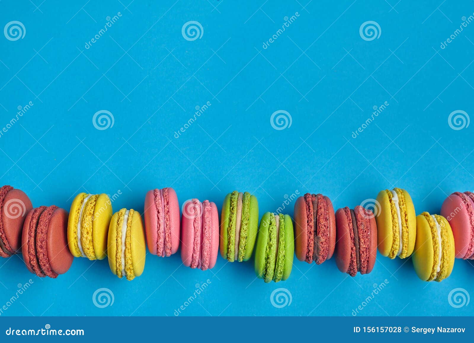 Colored Macaron or Macaroon, Sweet Meringue-based Confection on Blue ...