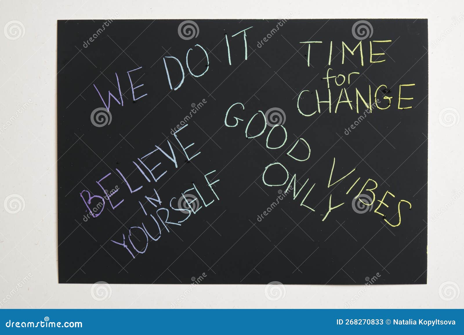 Colored Motivational Slogans are Scratched on on a Black Engraving