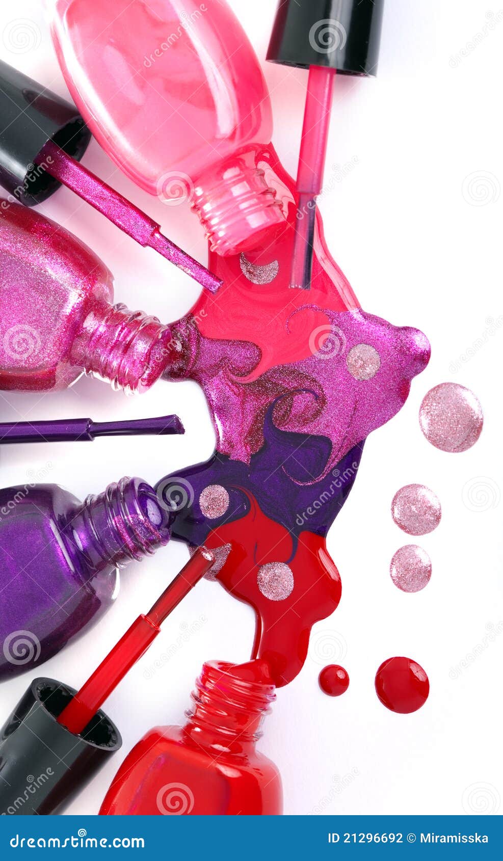 colored nail polish spilling from bottles