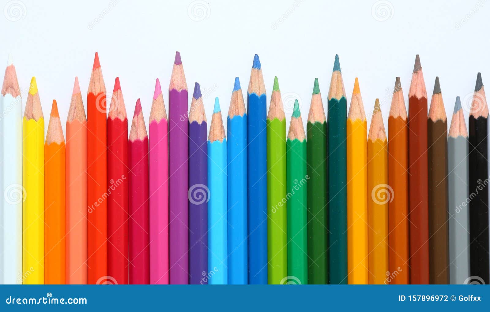 Colored pencil crayons in a row on white background Background