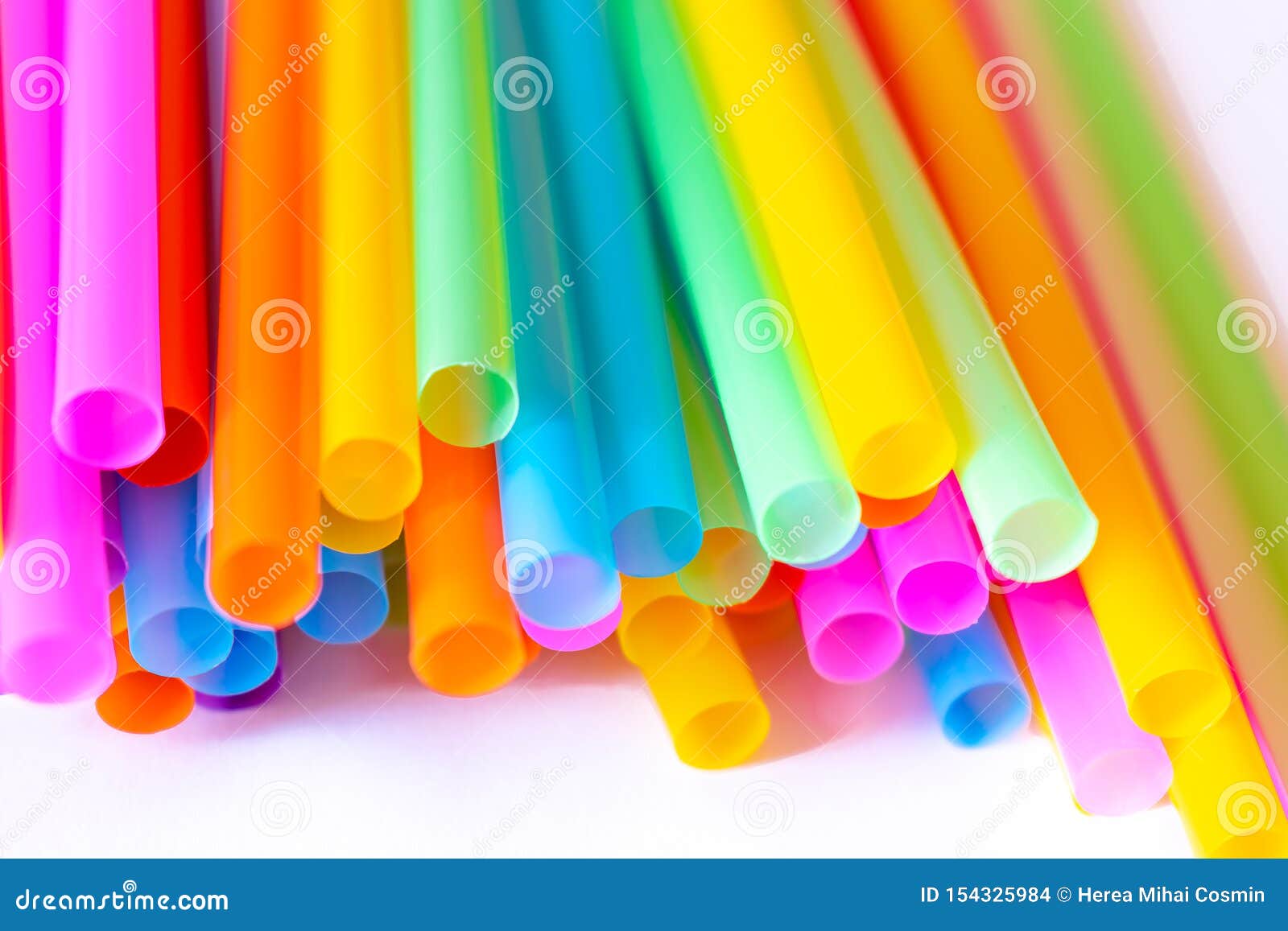 Colored Plastic Drinking Straws on a White Background Stock Photo