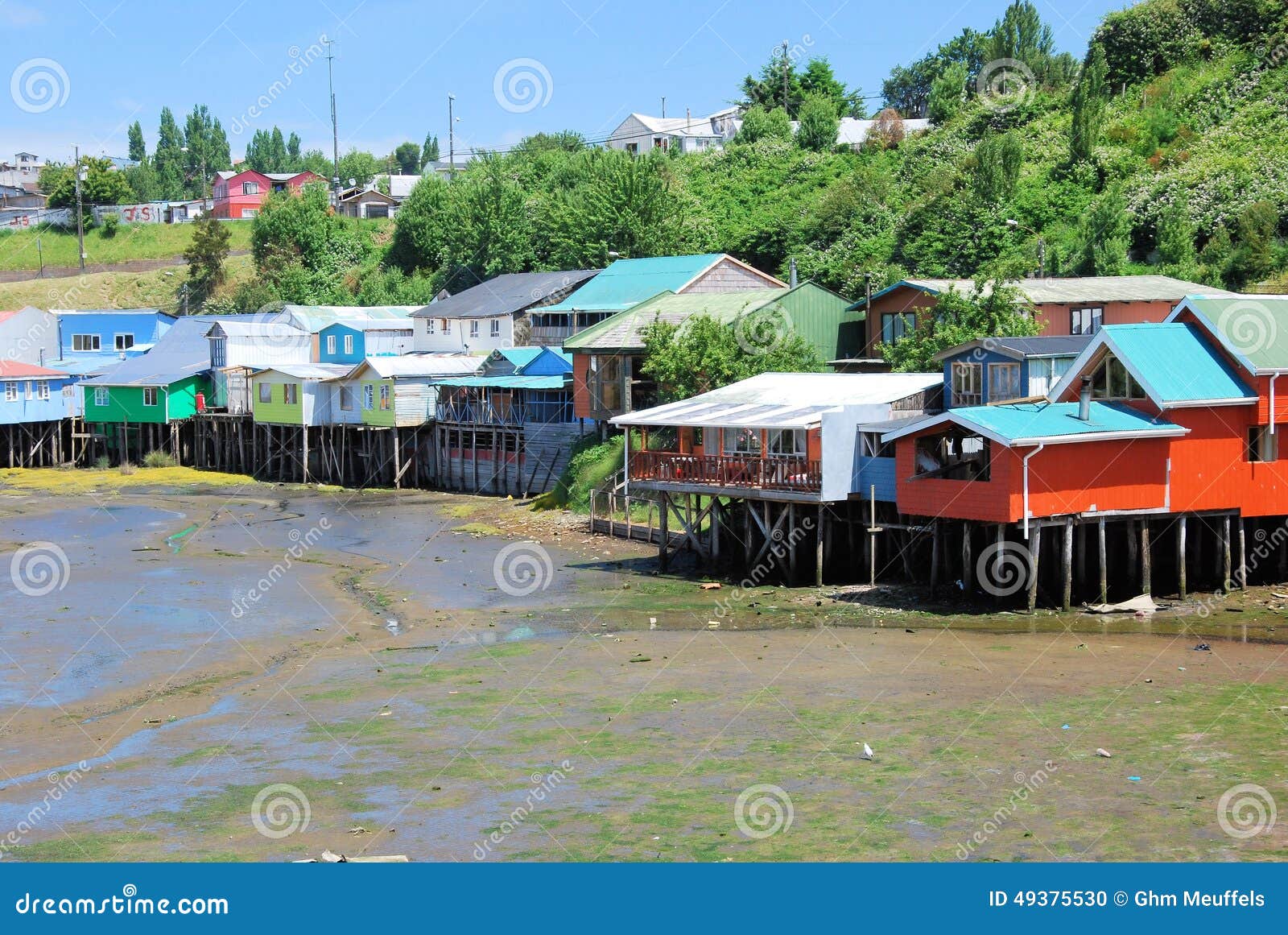 colored stilt houses castro during low tide, chiloe island, chile