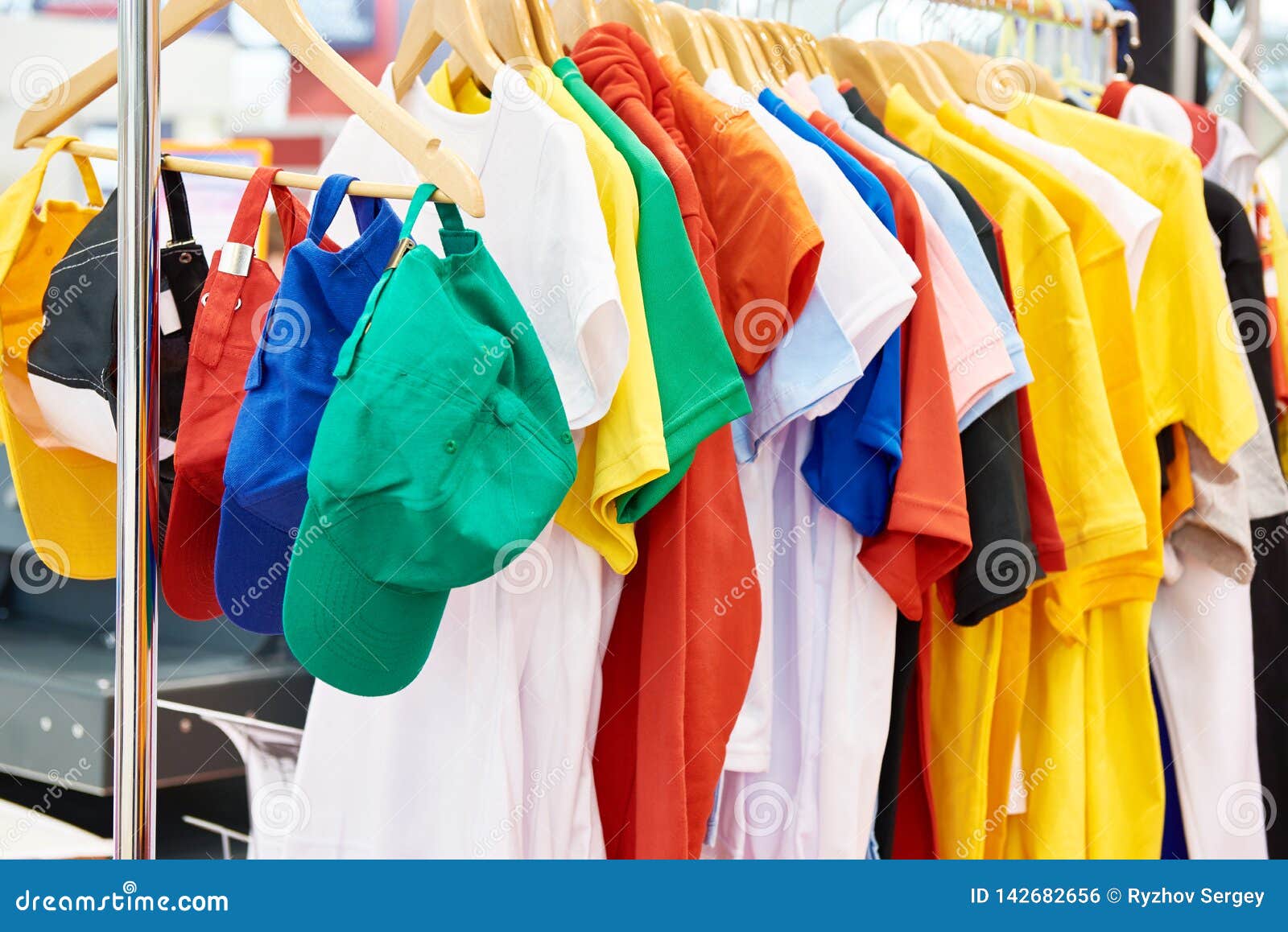 Colored T-shirts and Caps in Store Stock Photo - Image of caps ...