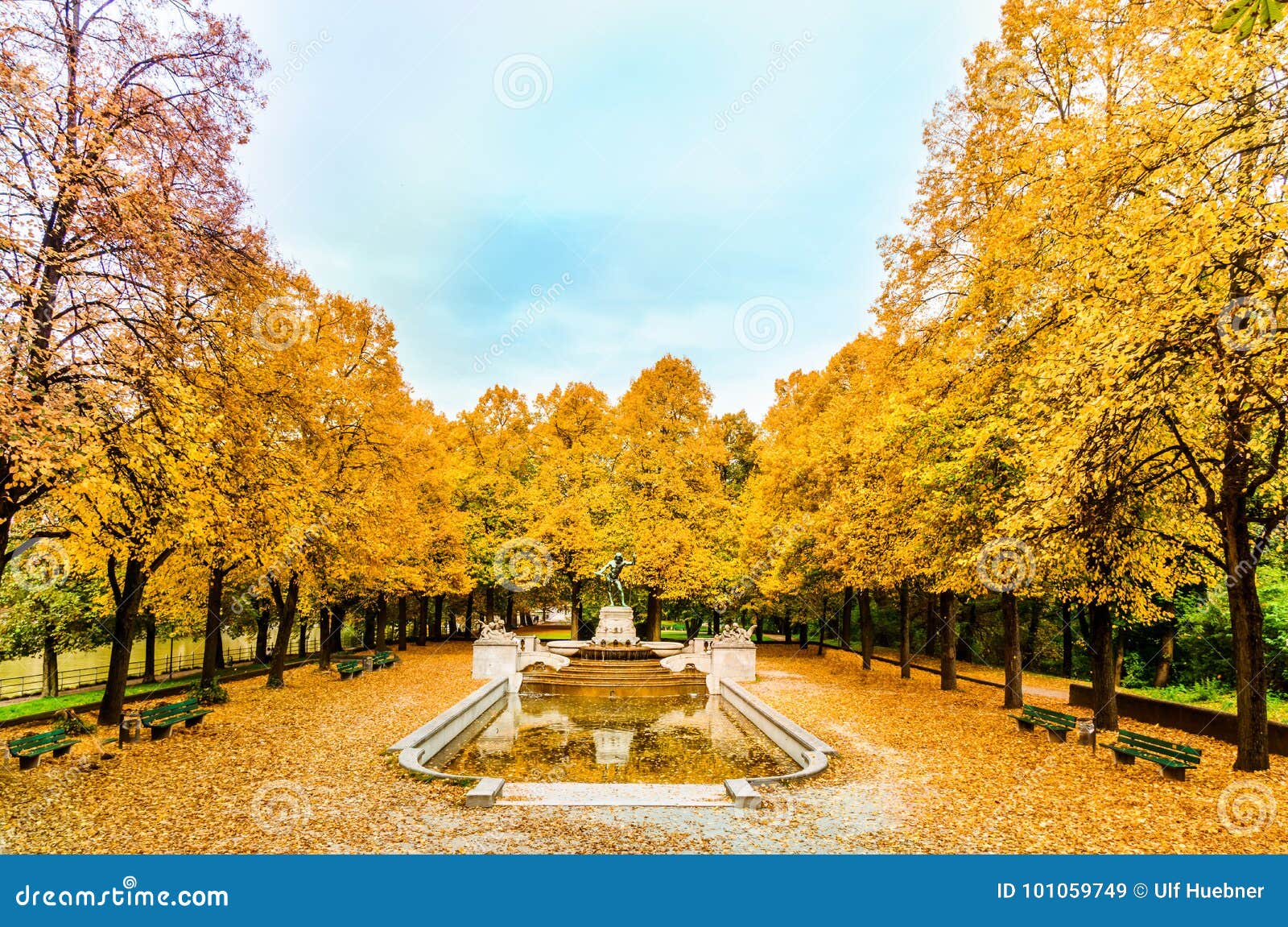 colorful autumn trees arround vater rhein fountain in munich