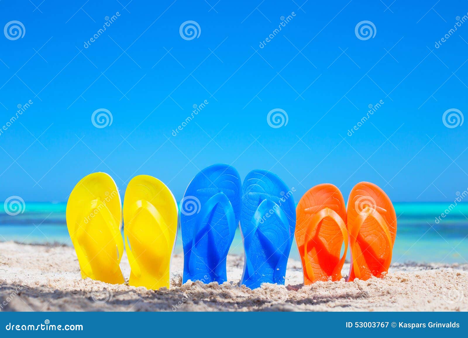 colorful beach flip flops sandals on the beach