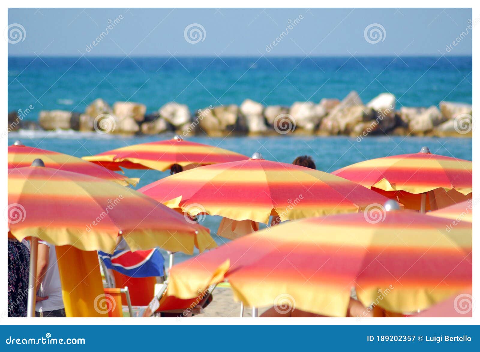 Colorful Beach Umbrellas on a Mediterranean Sandy Beach. Stock Image