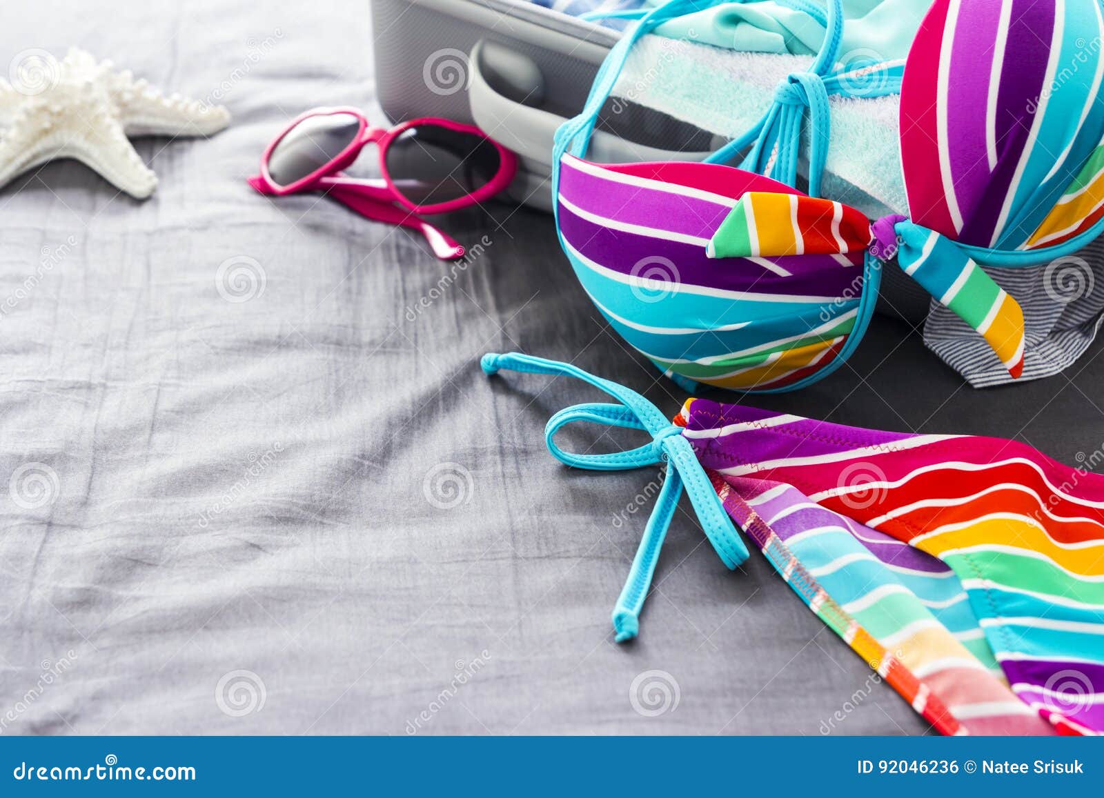 Colorful bikini on the bed stock photo. Image of eyeglasses - 92046236