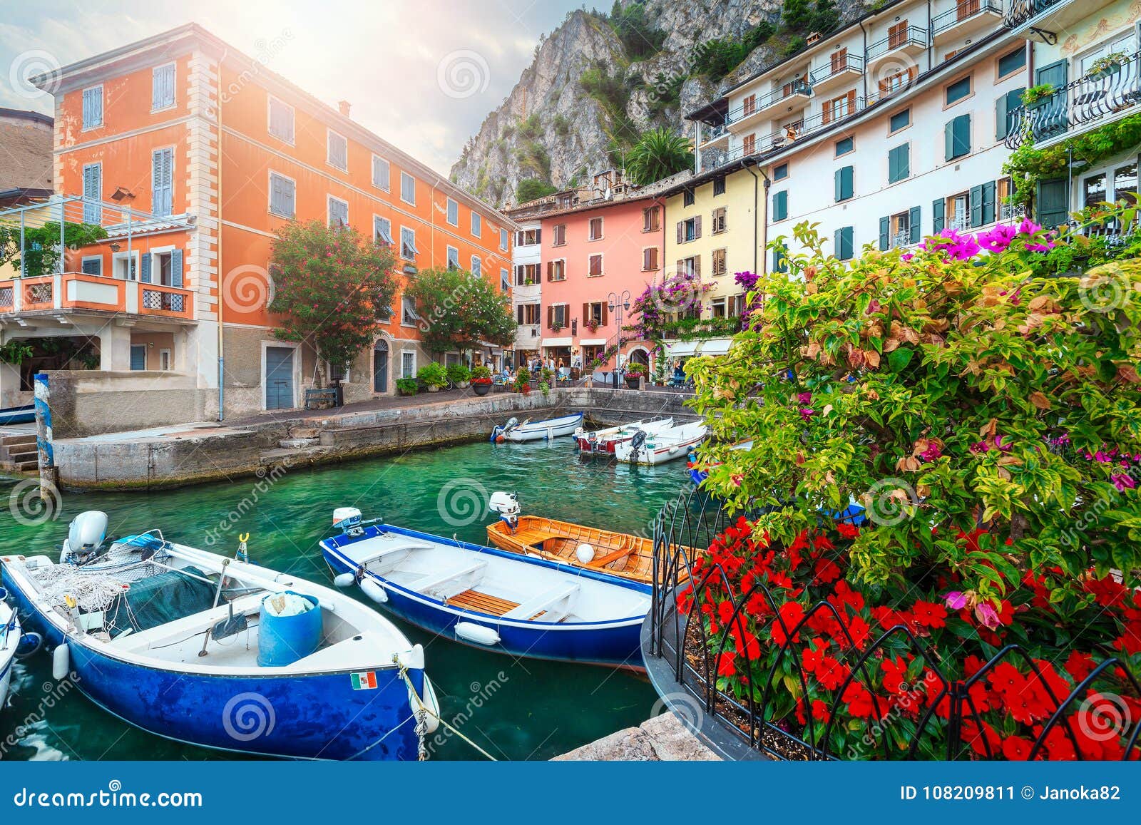 colorful boats in harbor of limone sul garda, lombardy, italy