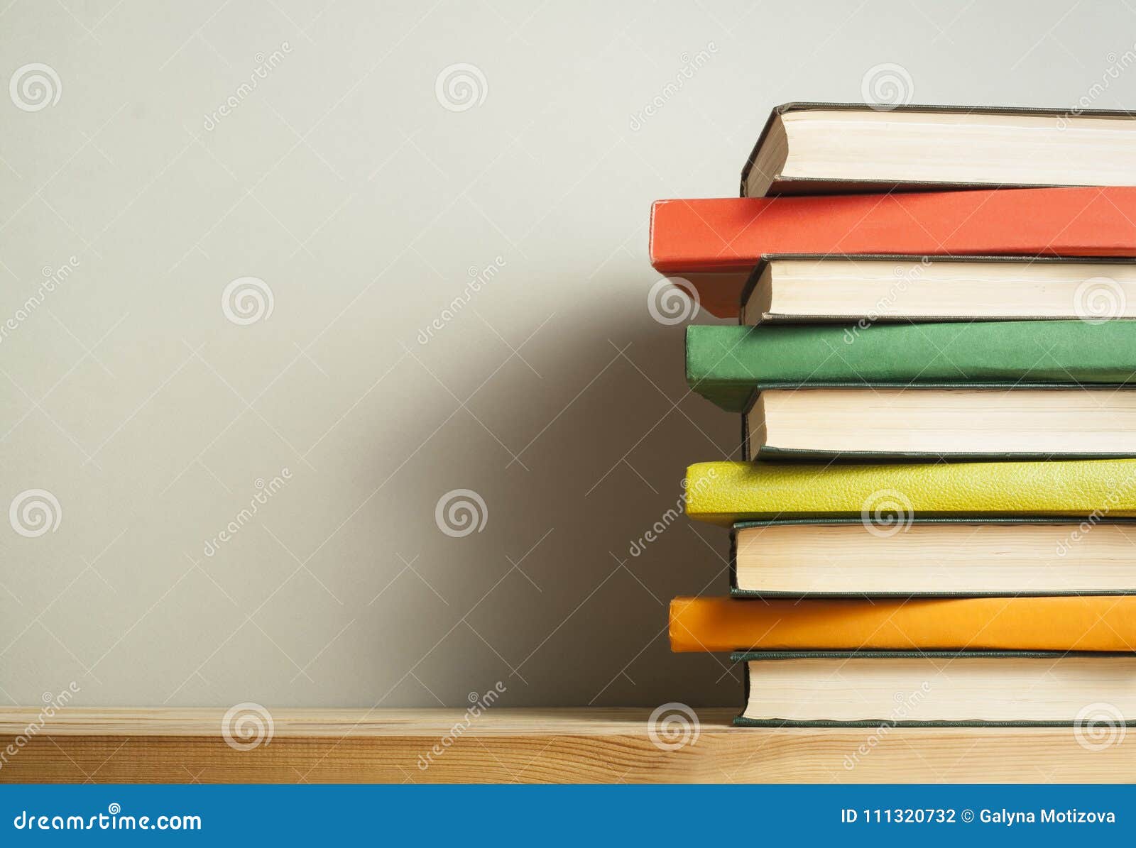 Stack Of Colorful Books On Wooden Desk Copy Space For Text Back