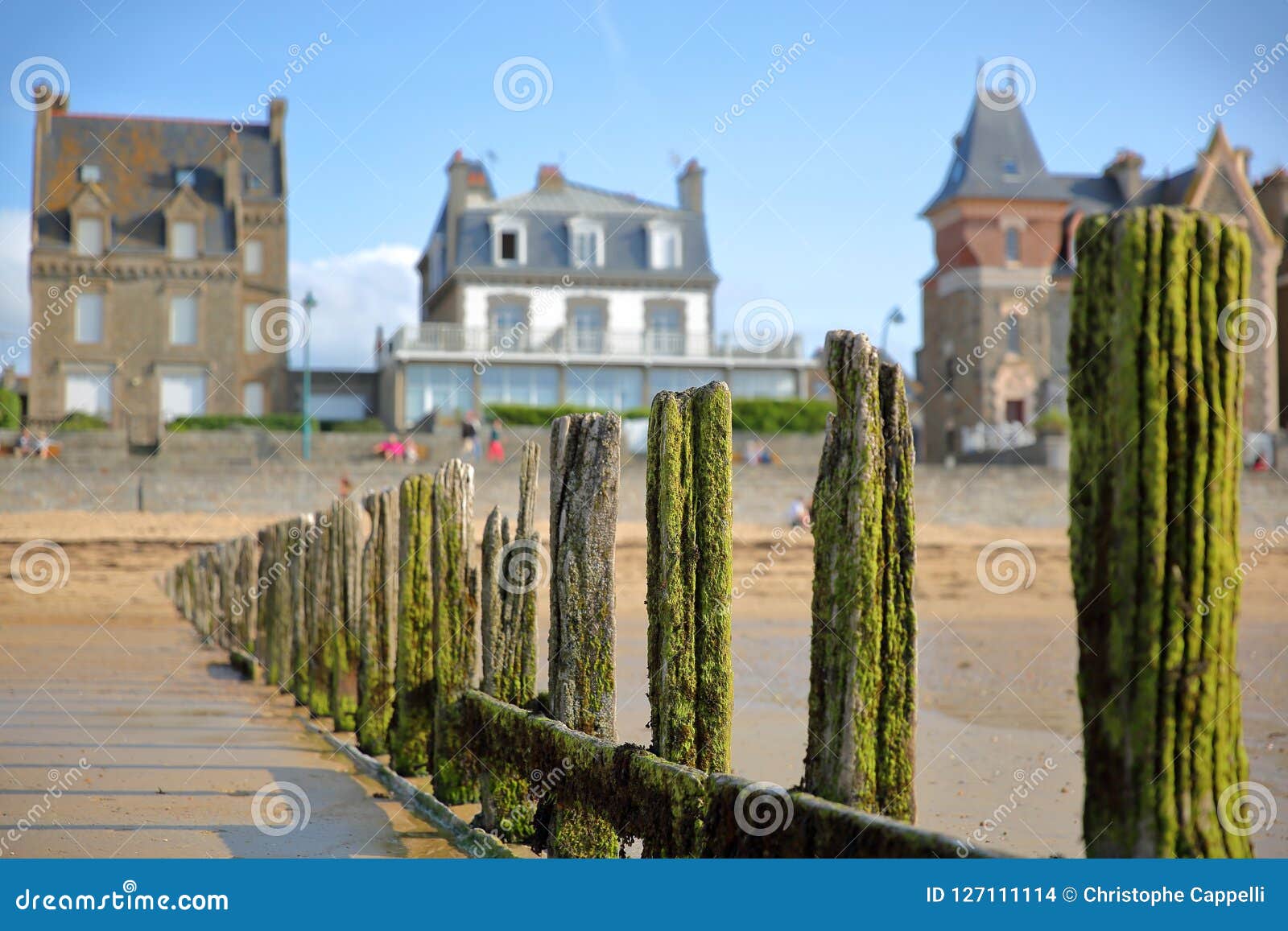 colorful breakwaters located on sillon beach with colorful house facades in the background, saint malo