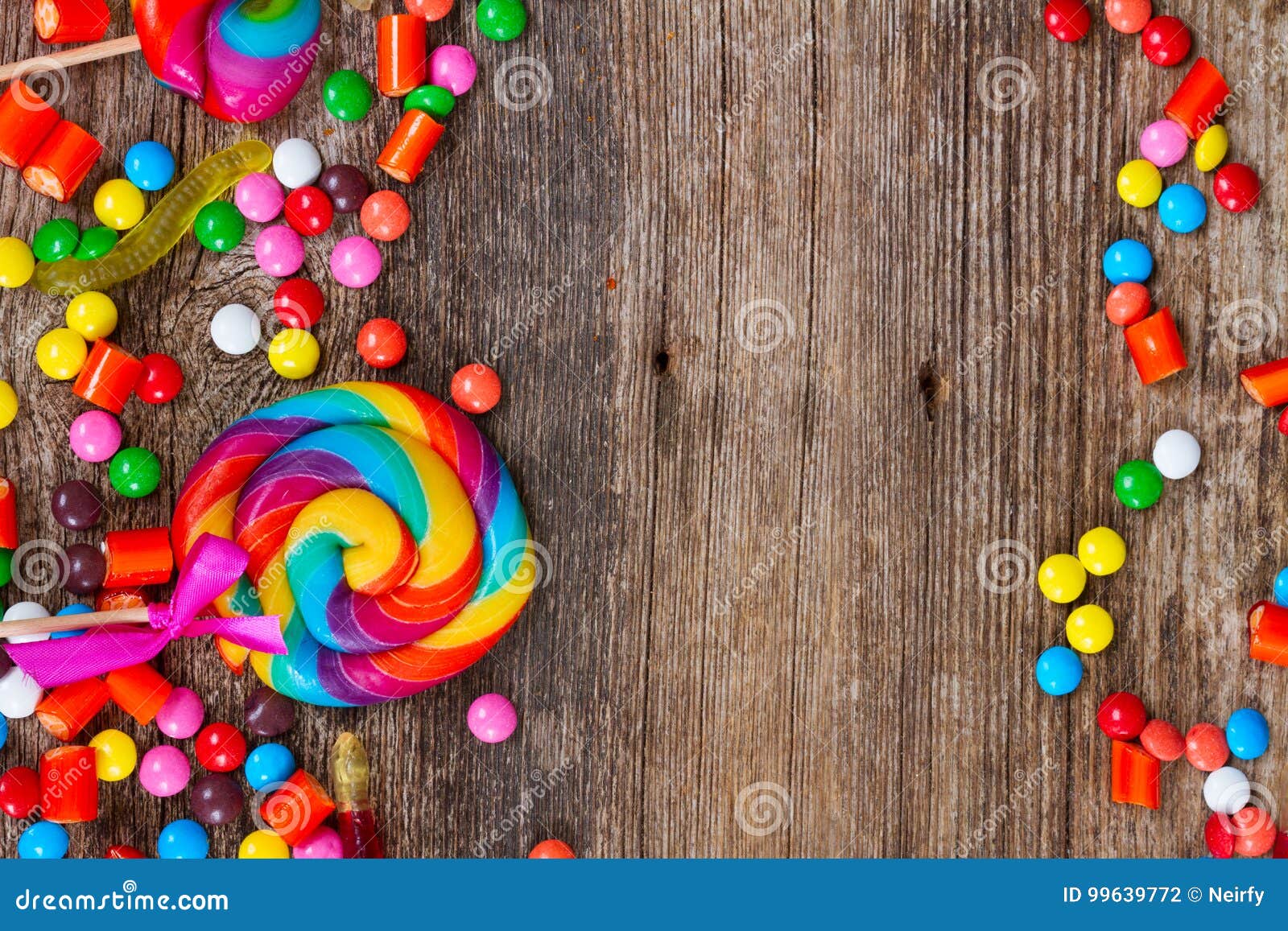 Colorful candies on wood stock photo. Image of space - 99639772