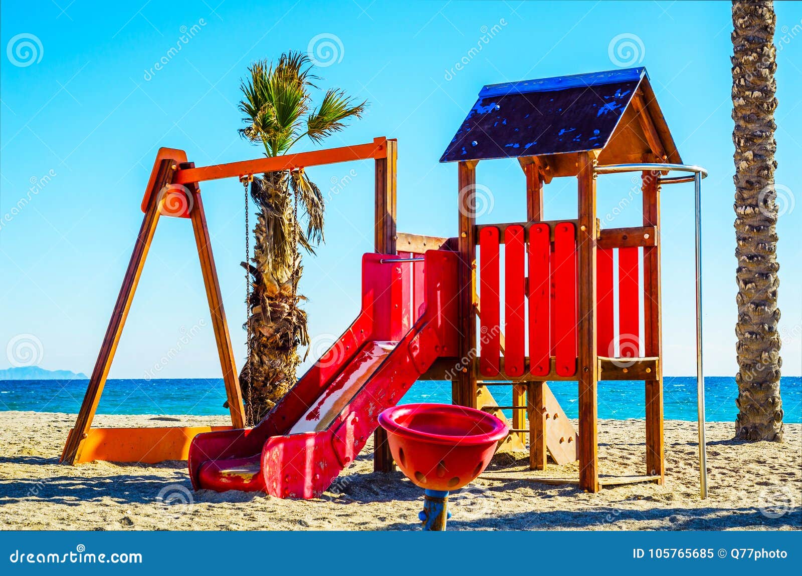 Colorful children`s Playground on the beach on a hot day, Playground for children near the sea, relax and fun