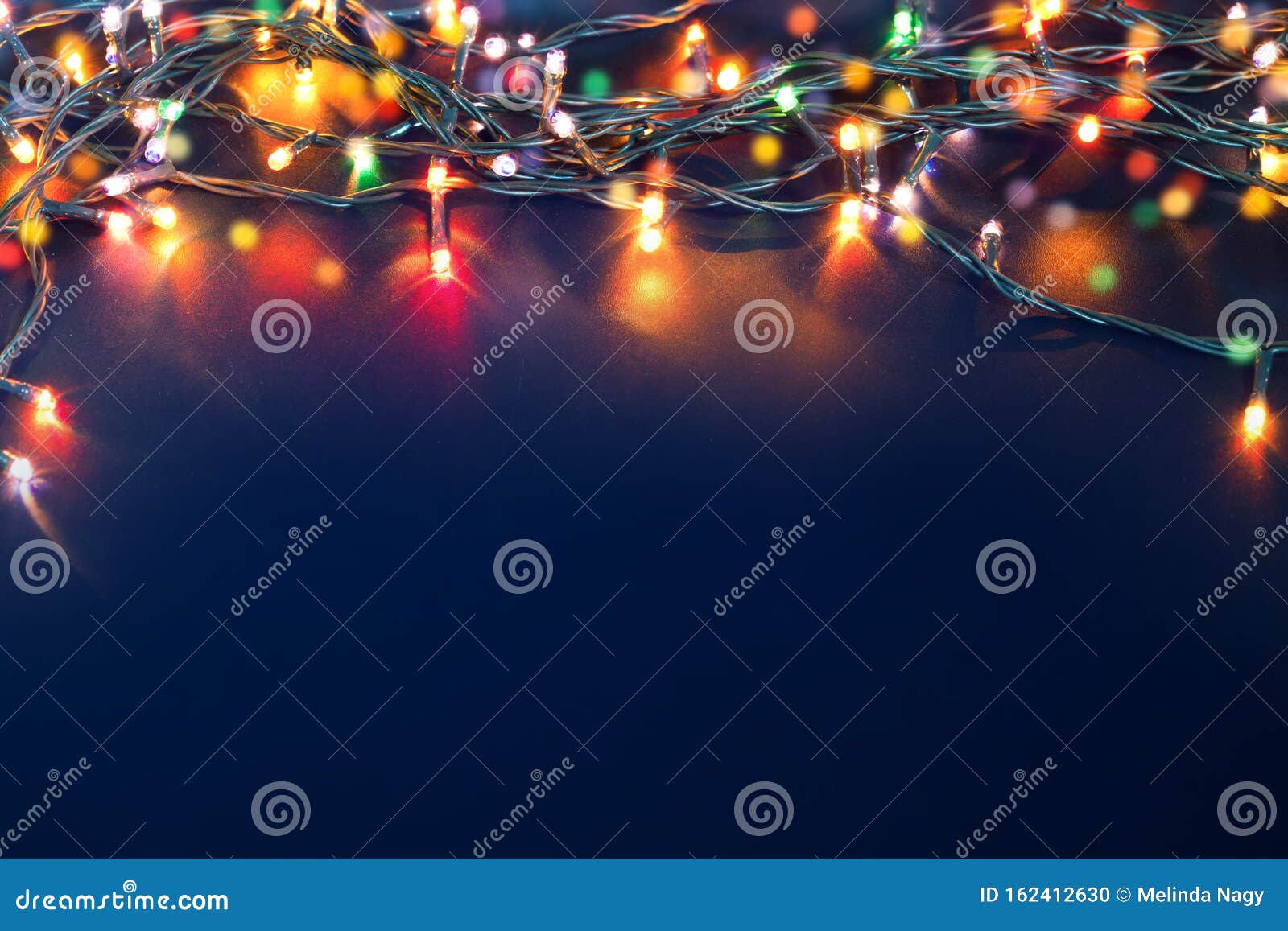 Colorful Christmas Lights on Blue Background Stock Photo - Image of