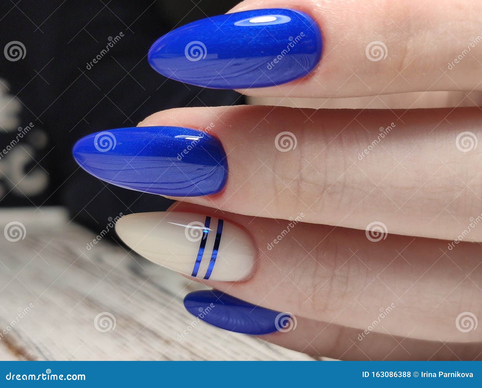 Closeup shot of very nice stylish trendy female manicure nail art with  decoration, pattern and blue nail polish. Professional manicure in beauty  salon Stock Photo | Adobe Stock