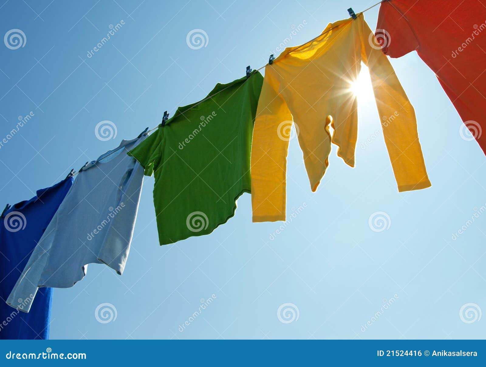 colorful clothes on a laundry line and sun shining