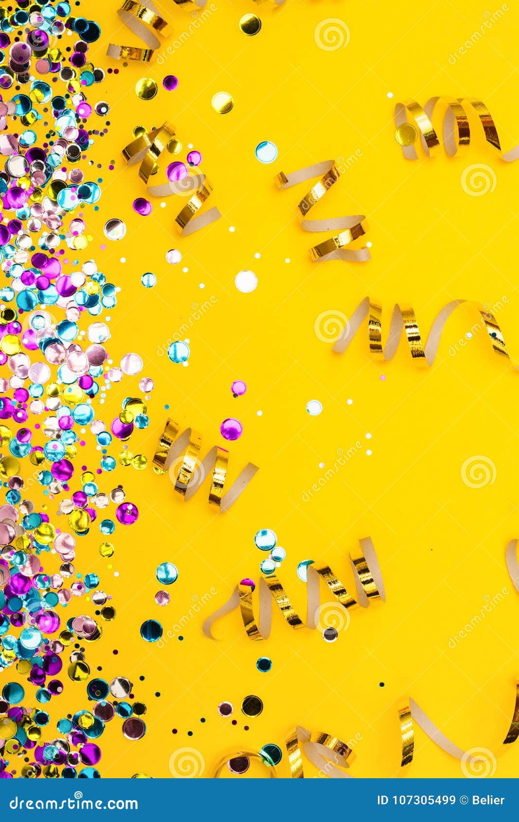 Colorful Confetti and Golden Coiled Streamers on Yellow Background ...