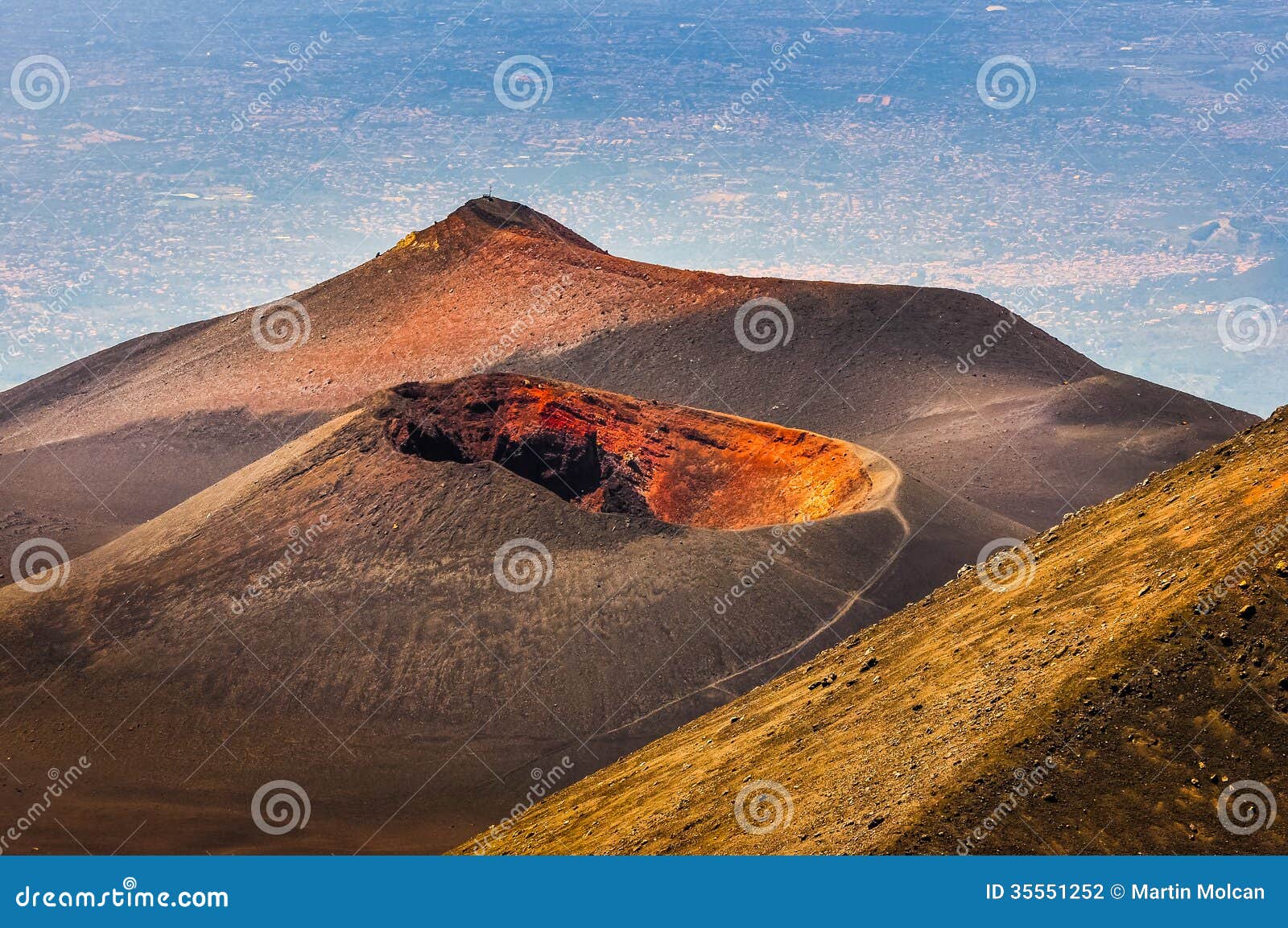 colorful crater of etna volcano with catania in background, sici