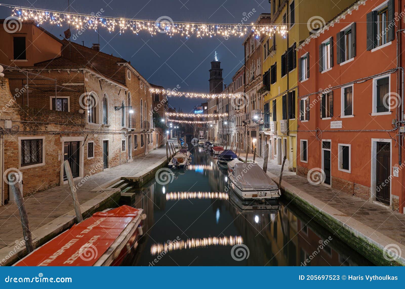 venice, italy february 18 , 2020.colorful decorated alley with christmas lights view fromthe  ponte dei pugni bridge