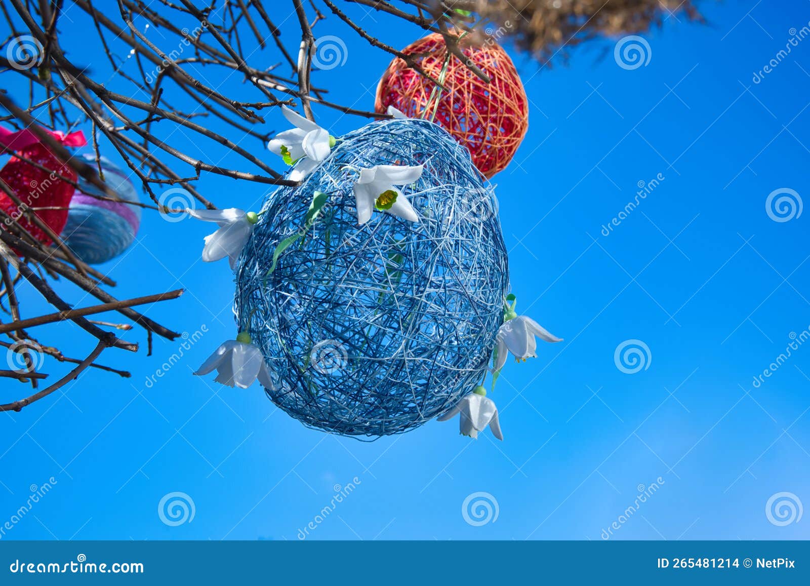 Colorful Easter Decorations Hanging on Tree Branches Stock Photo