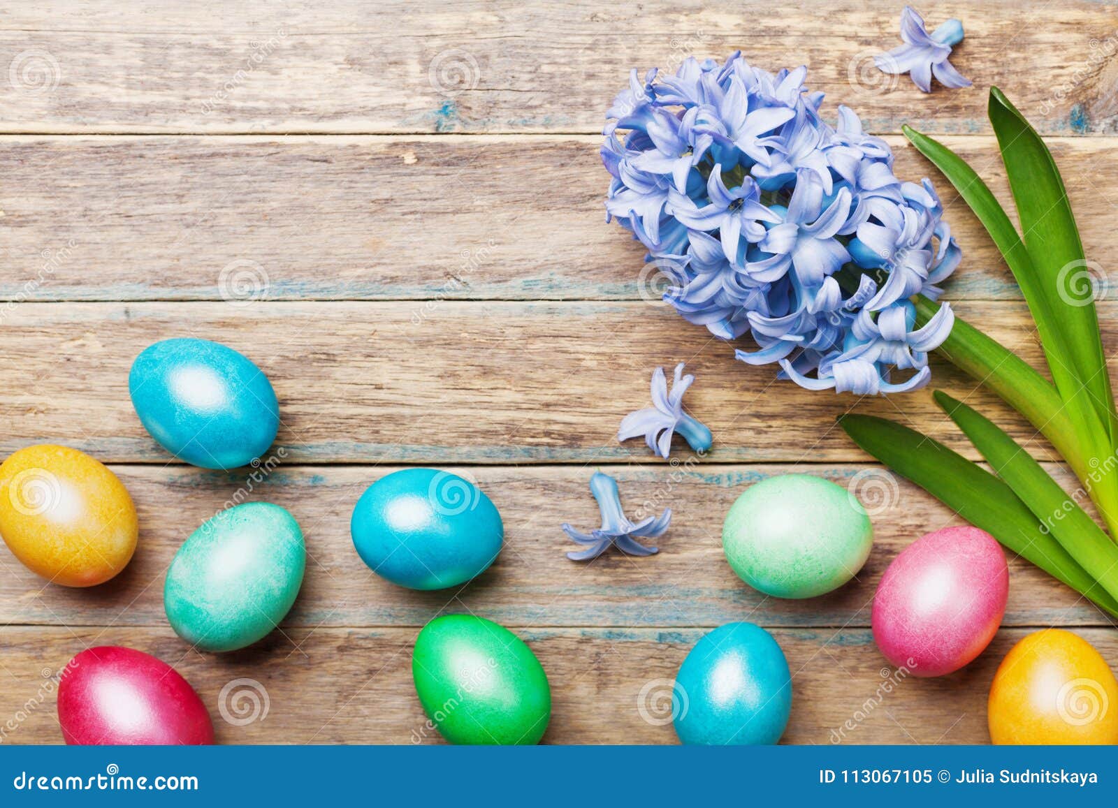 Colorful Easter Eggs Background with Flowers on Wooden Rustic Table Top ...
