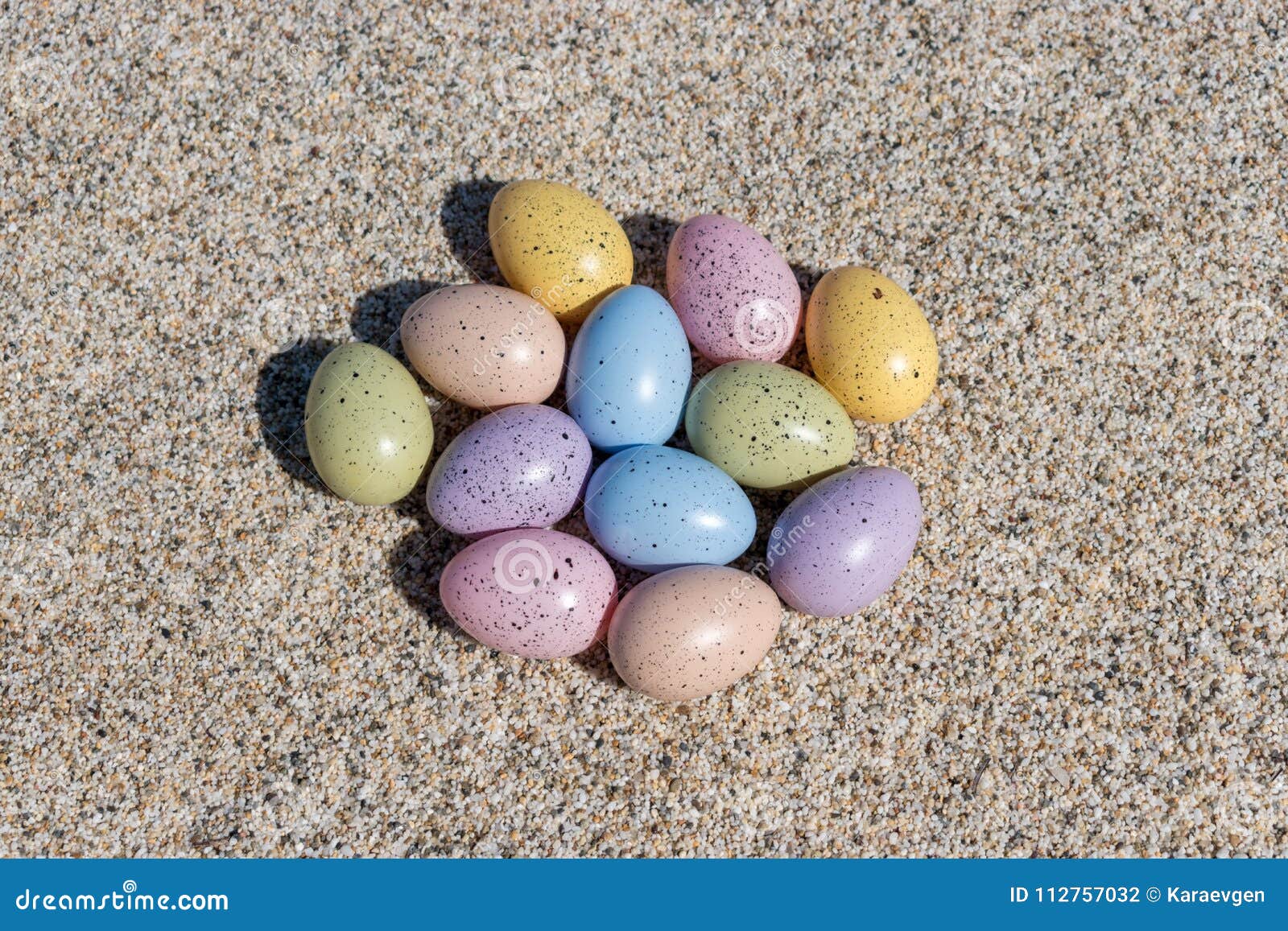 Colorful Easter Eggs on the Beach in Sunny Day. Stock Photo Image of