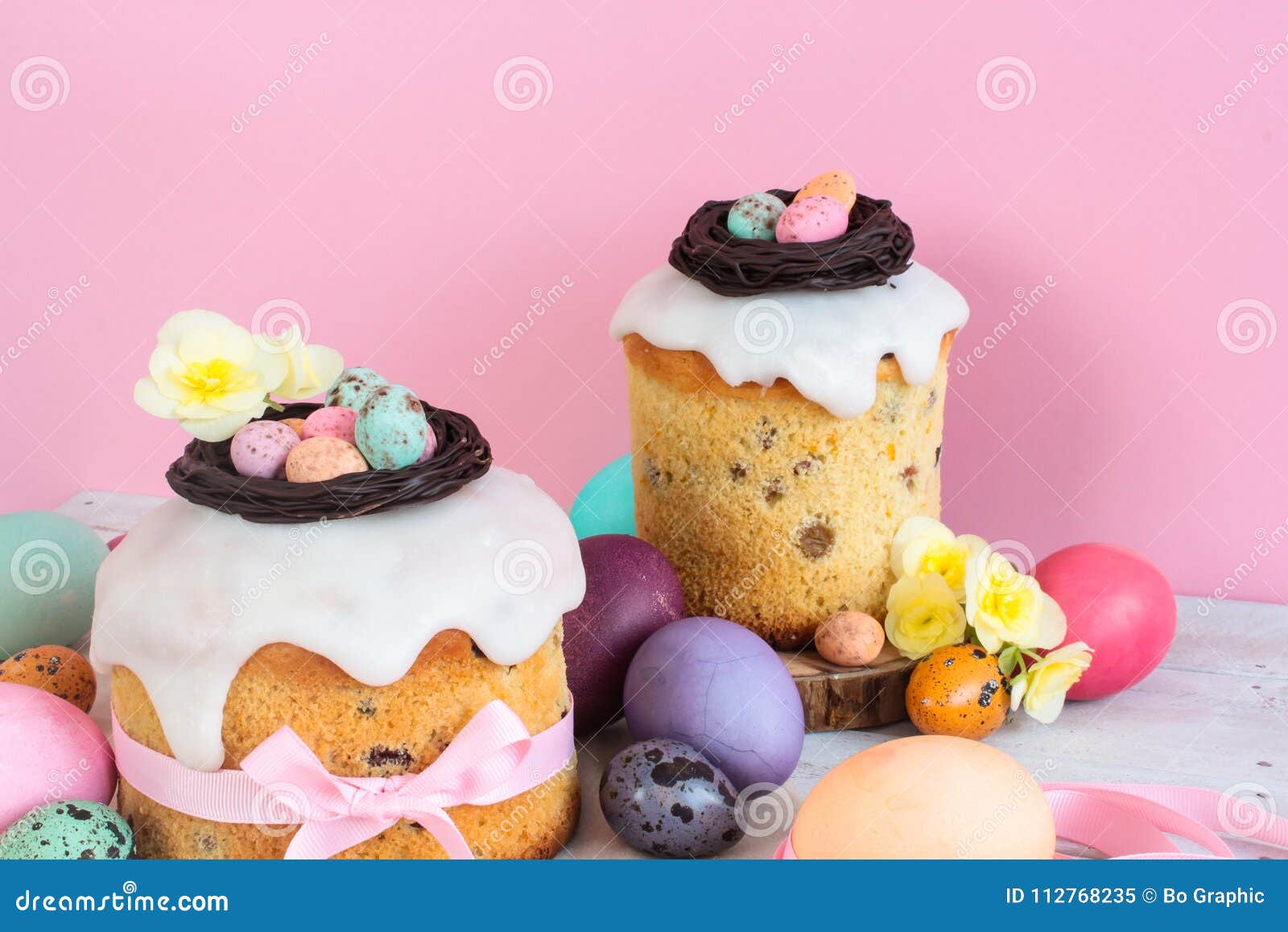 colorful easter spring stillife in soft light and trendy pastel colors. traditional cake with chocolate nest, candy and qail eggs