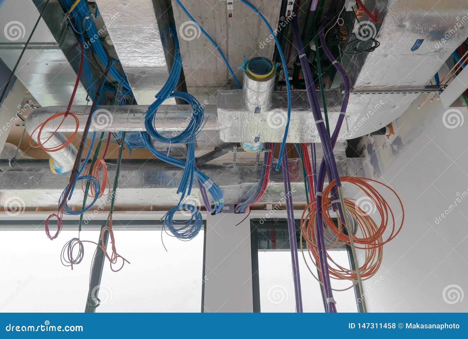 Colorful Electrical Cables Hanging From The Ceiling In Spirals And