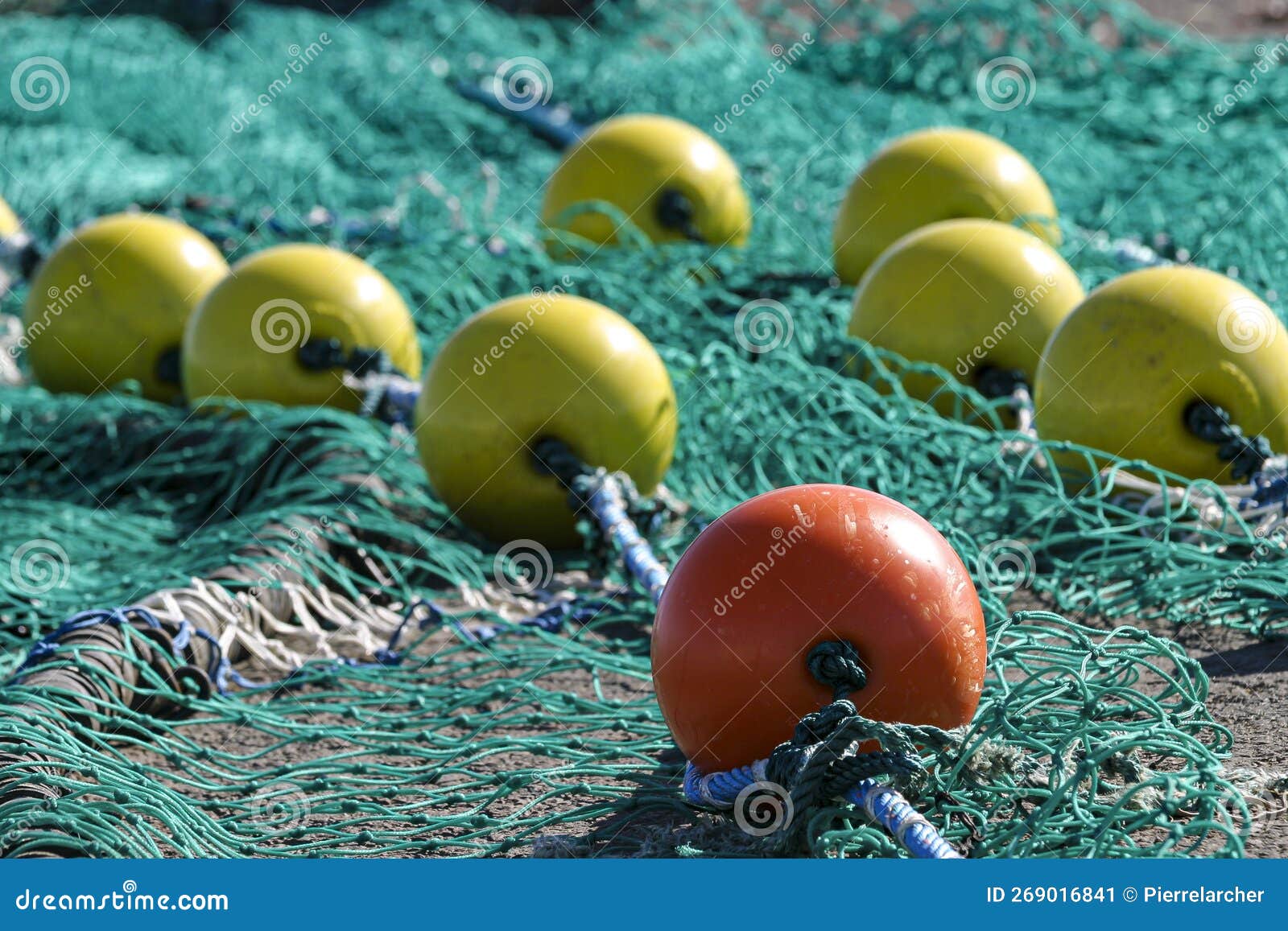 Premium Photo  Colored fishing nets lie on the pier against the background  of boats