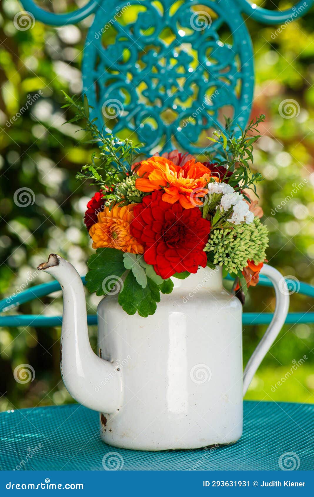 colorful flower bouquet with dalias in a enamel milk jug