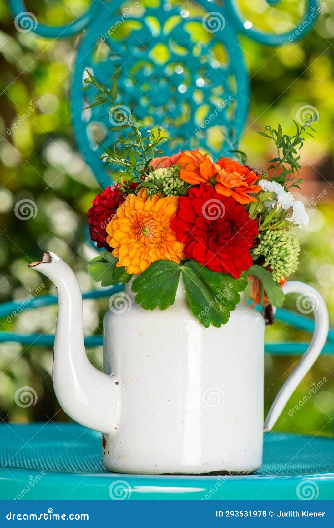 colorful flower bouquet with dalias in a enamel milk jug