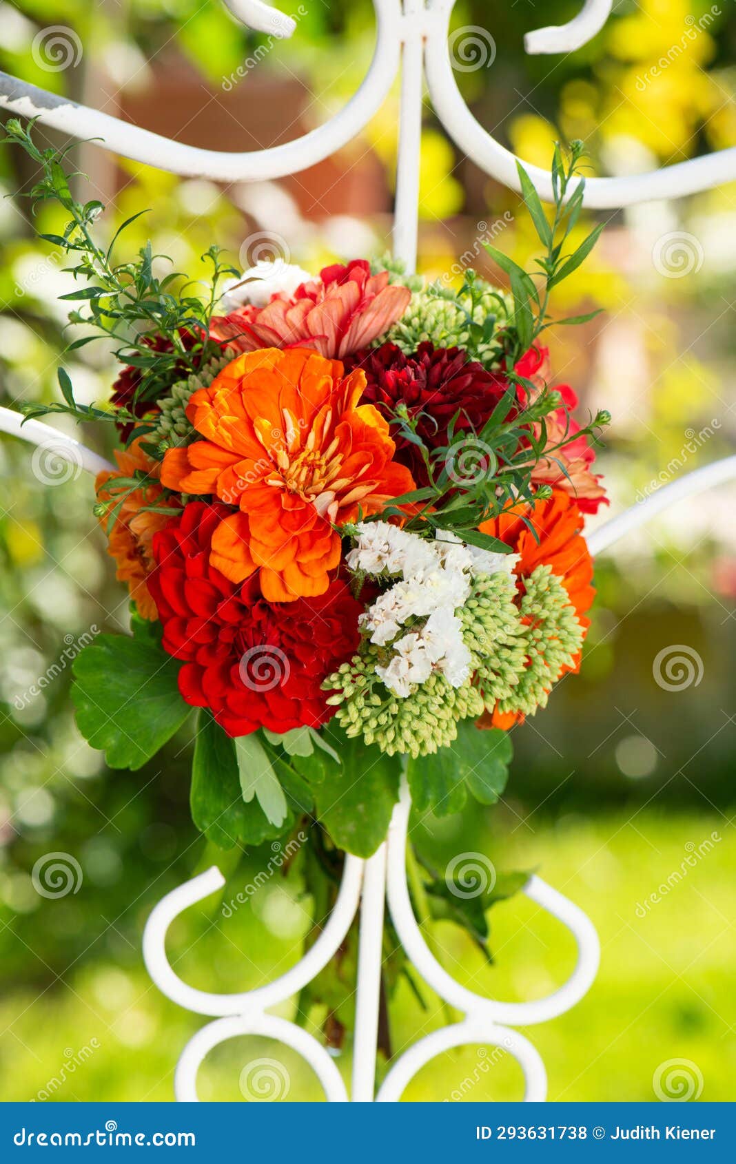 colorful flower bouquet with dalias on a trellis