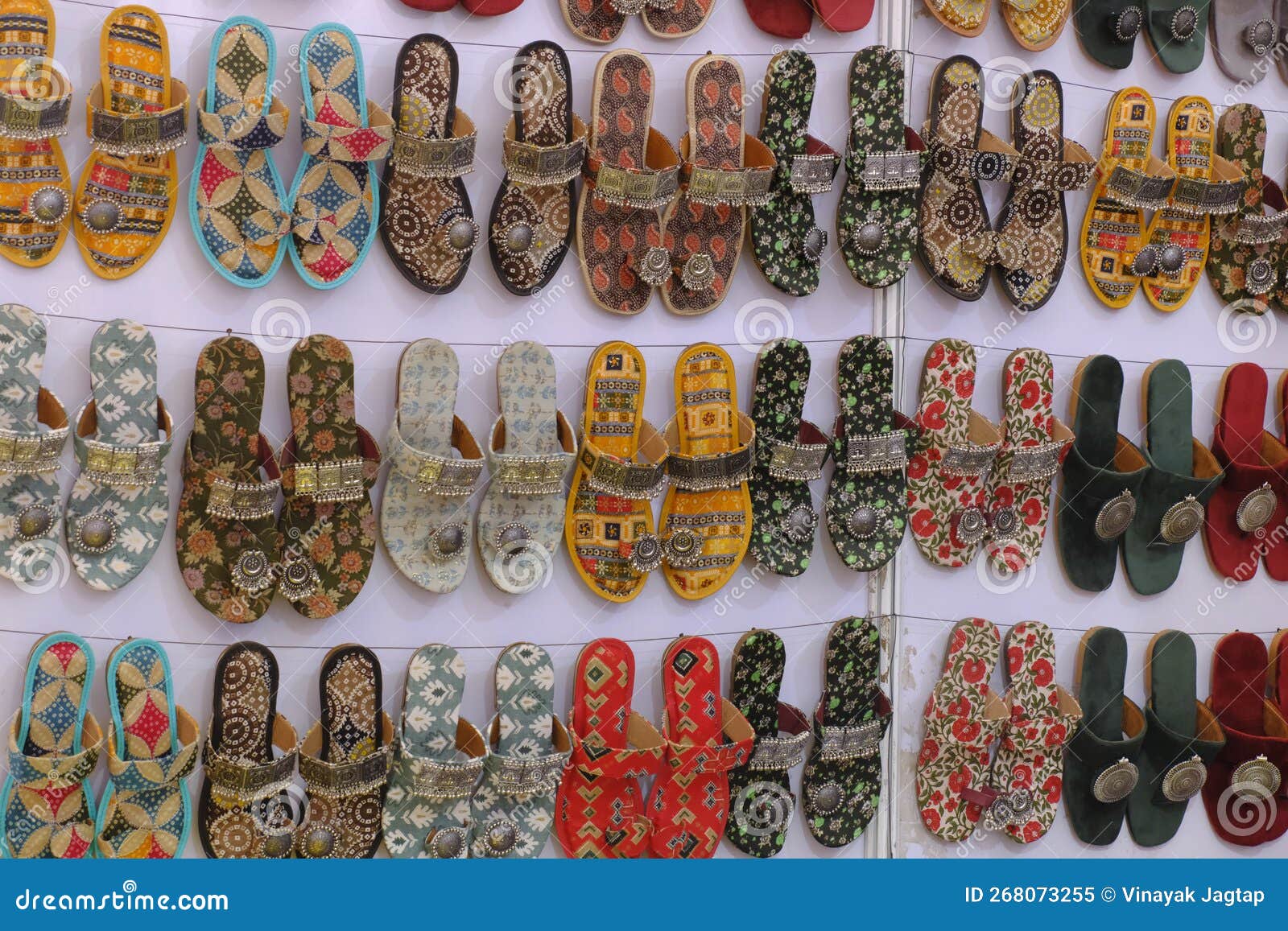 colorful handmade chappals (sandals) being sold in an indian market, handmade leather slippers, traditional footwear