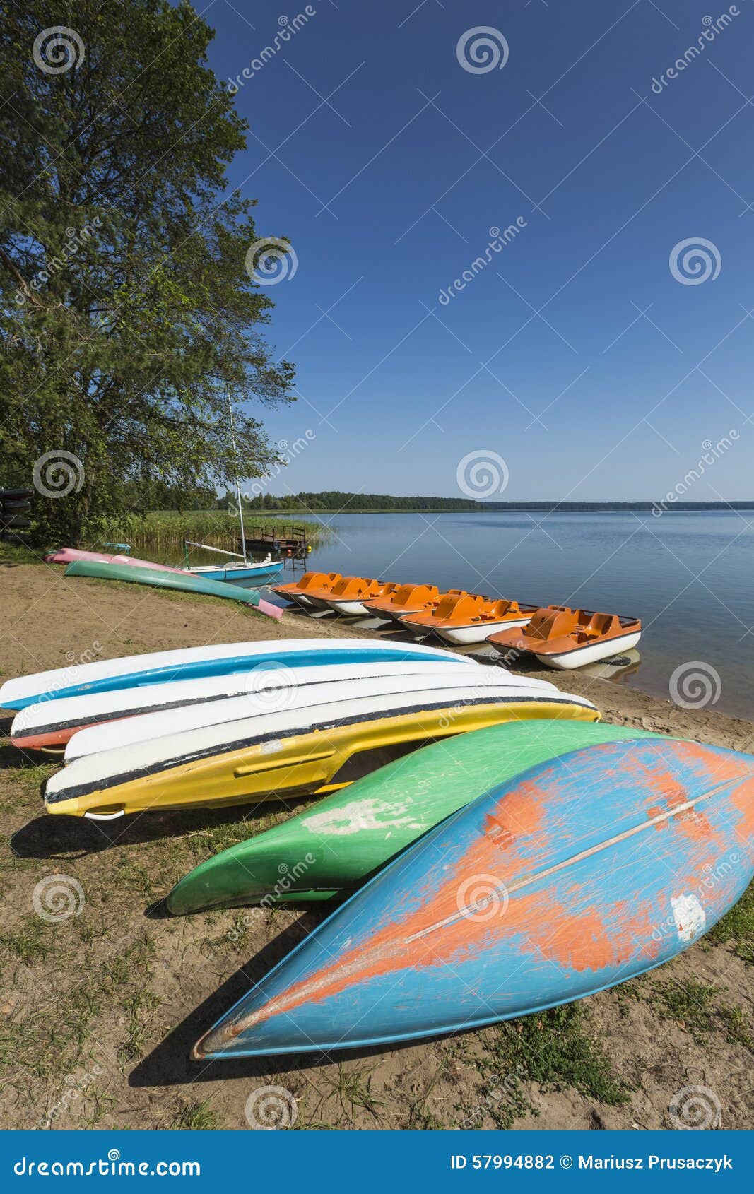 colorful kayaks moored on lakeshore, goldopiwo lake, mazury, pol