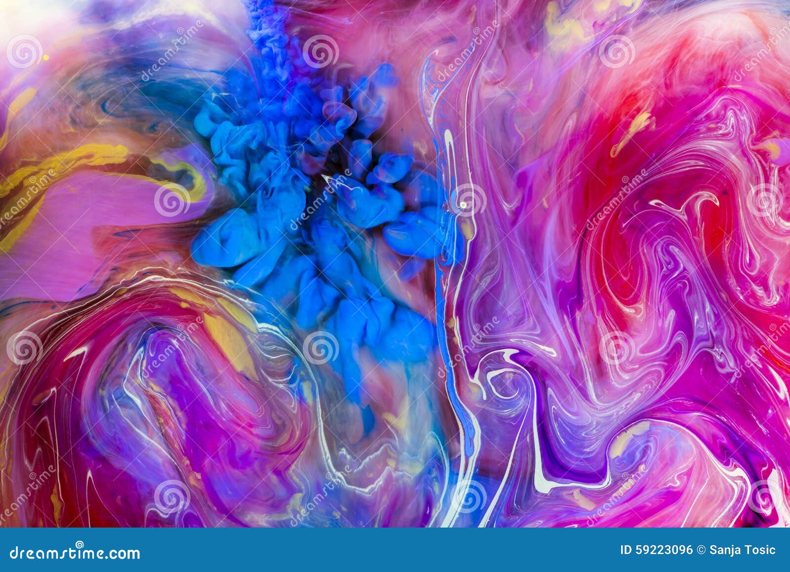 colorful liquids underwater. blue color cloud and pink mix.