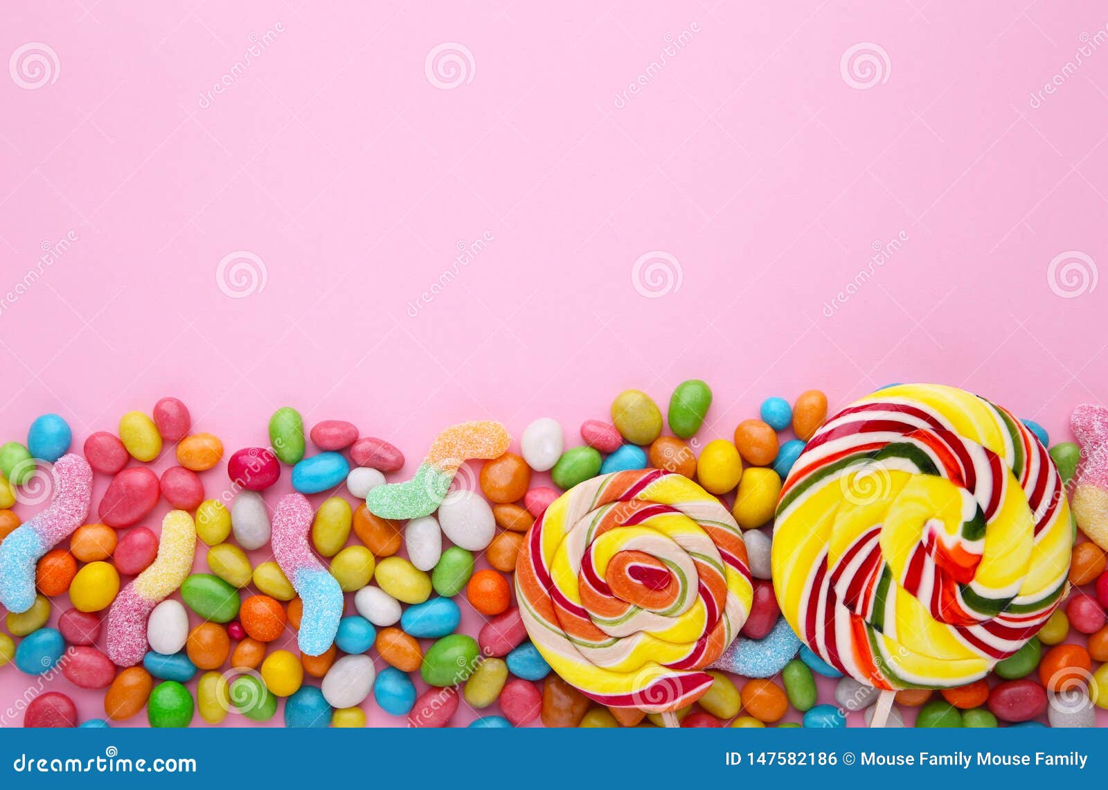 Colorful Lollipops and Different Colored Round Candy on Pink Background ...