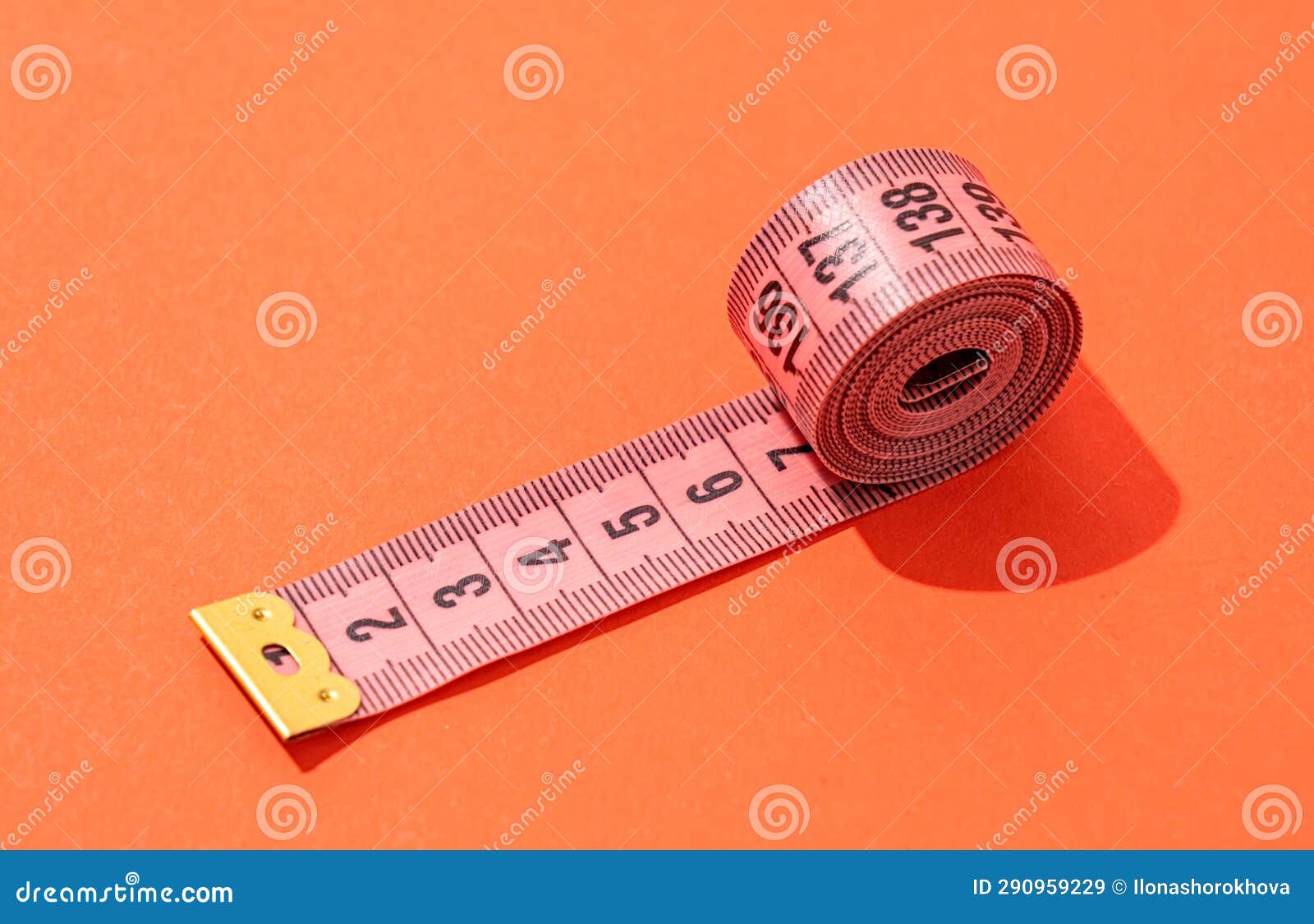 Colorful Measuring Tapes Top View on Bright Red Background Stock Image