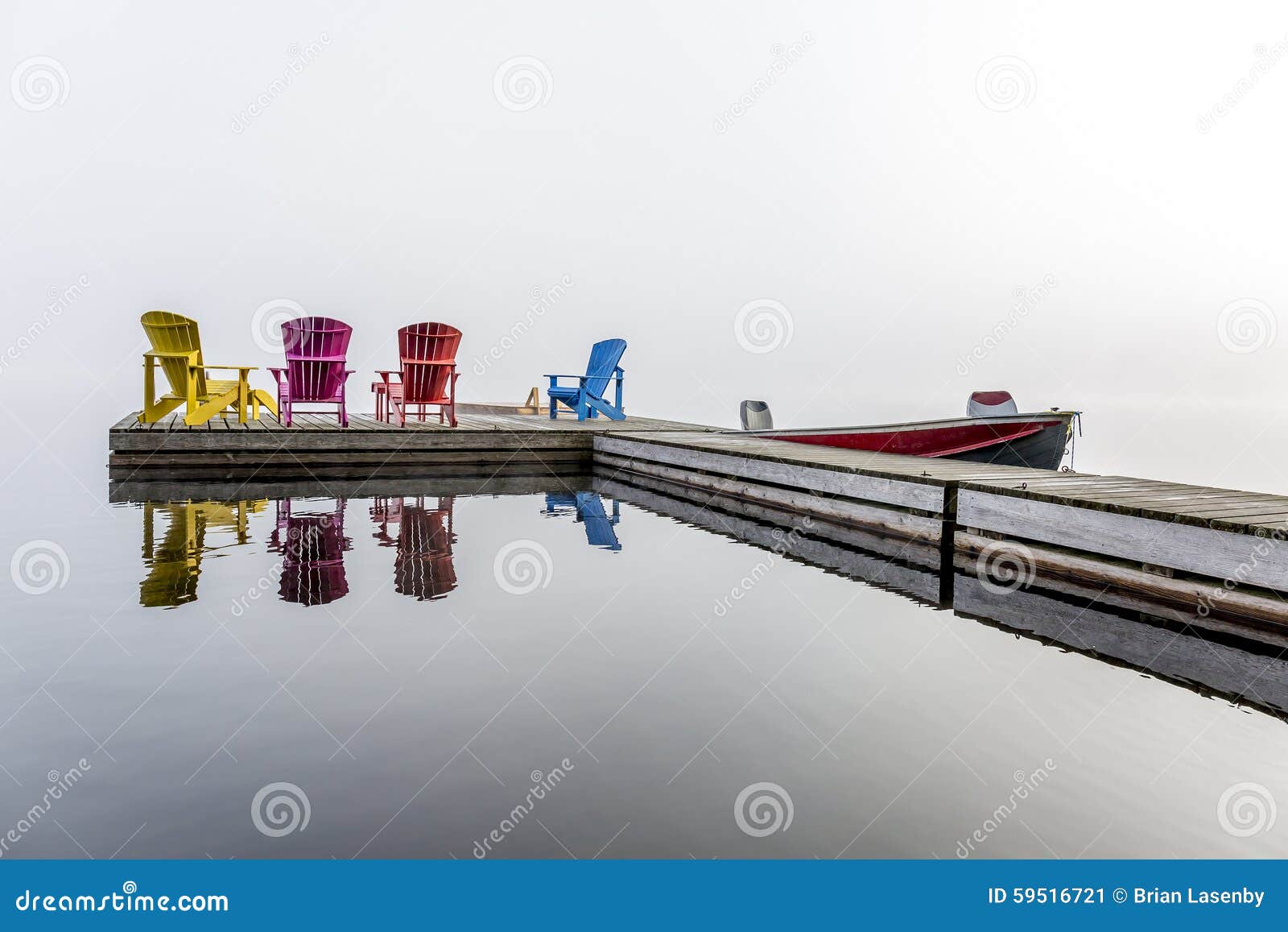 colorful muskoka chairs on a dock