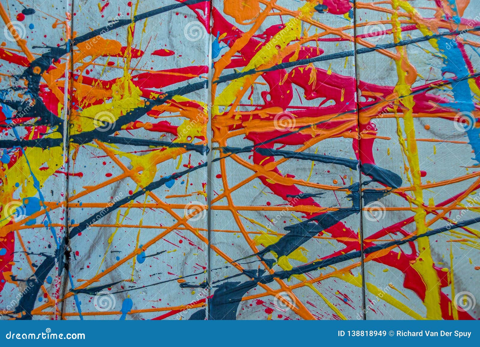 colorful paint splashes on a wood surface
