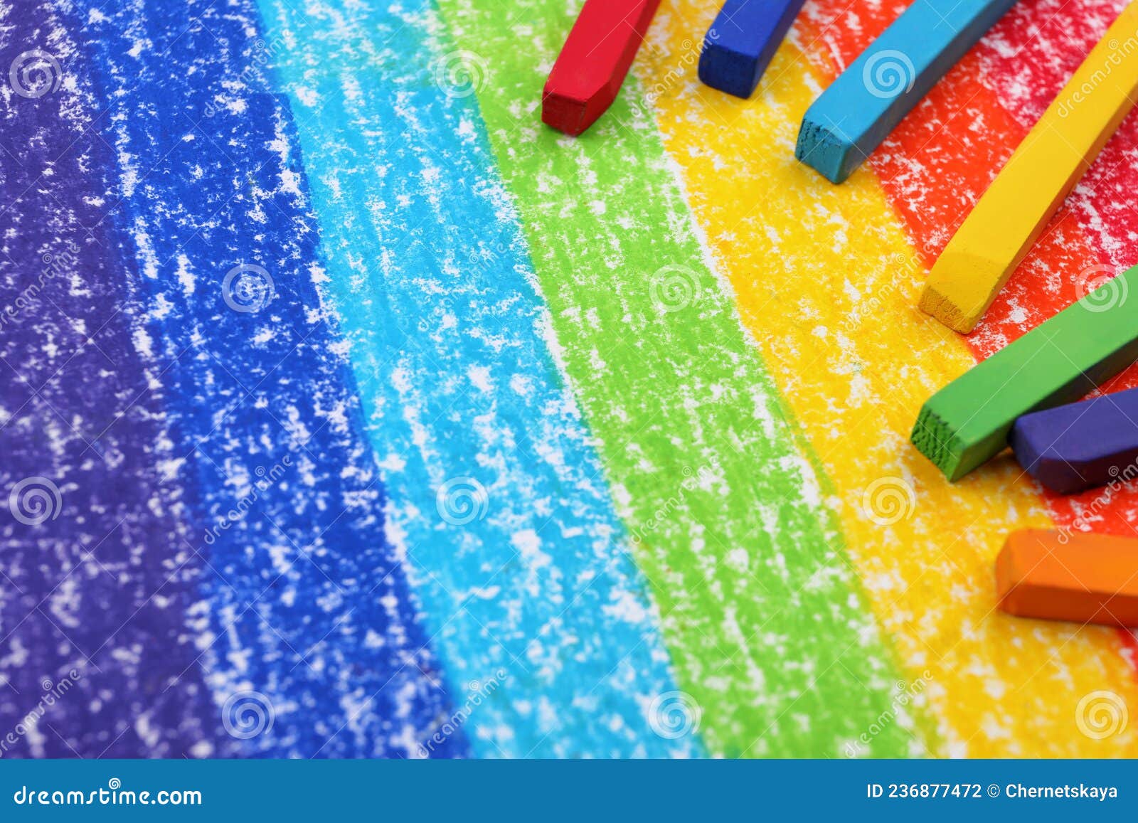 Colorful Pastel Chalks on Drawing of Rainbow. Space for Text Stock